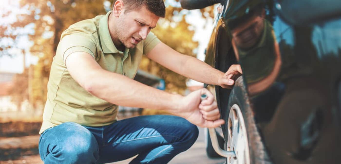 Changing a Tire with a Tire Iron Image